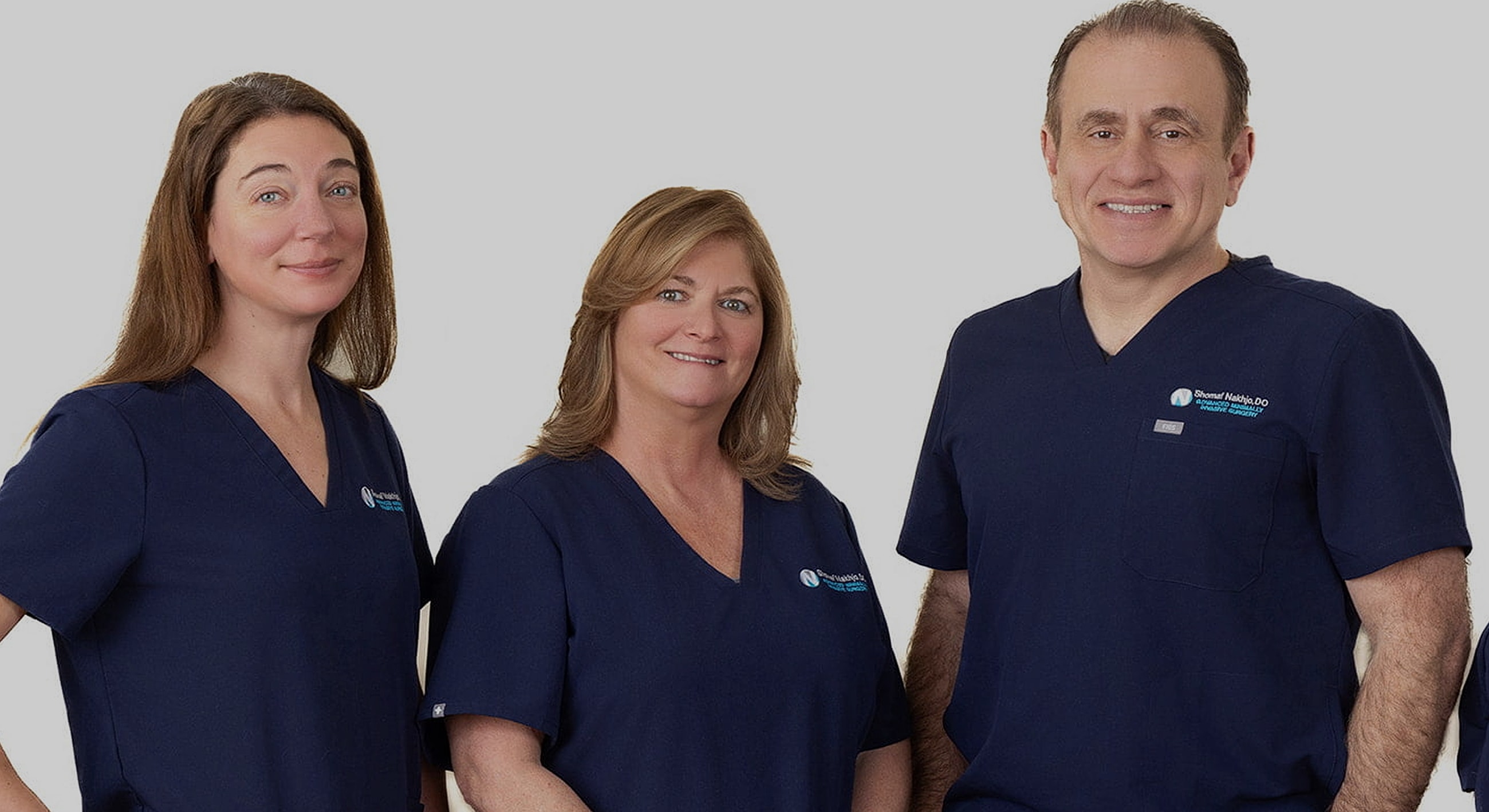 Medical professionals posing together in scrubs.