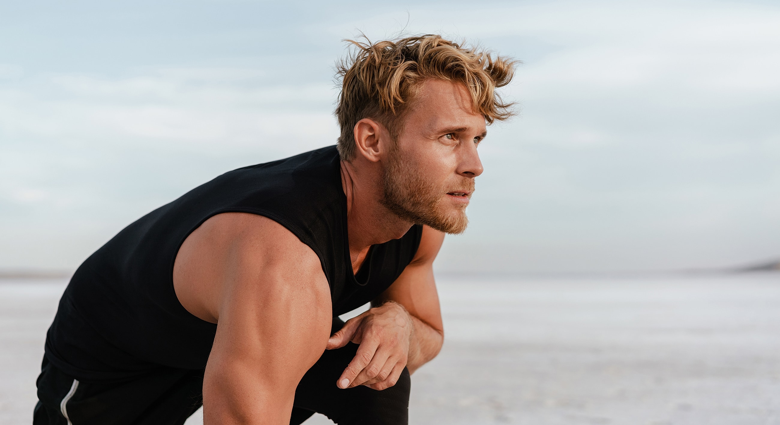 Athletic man preparing for physical activity outdoors.